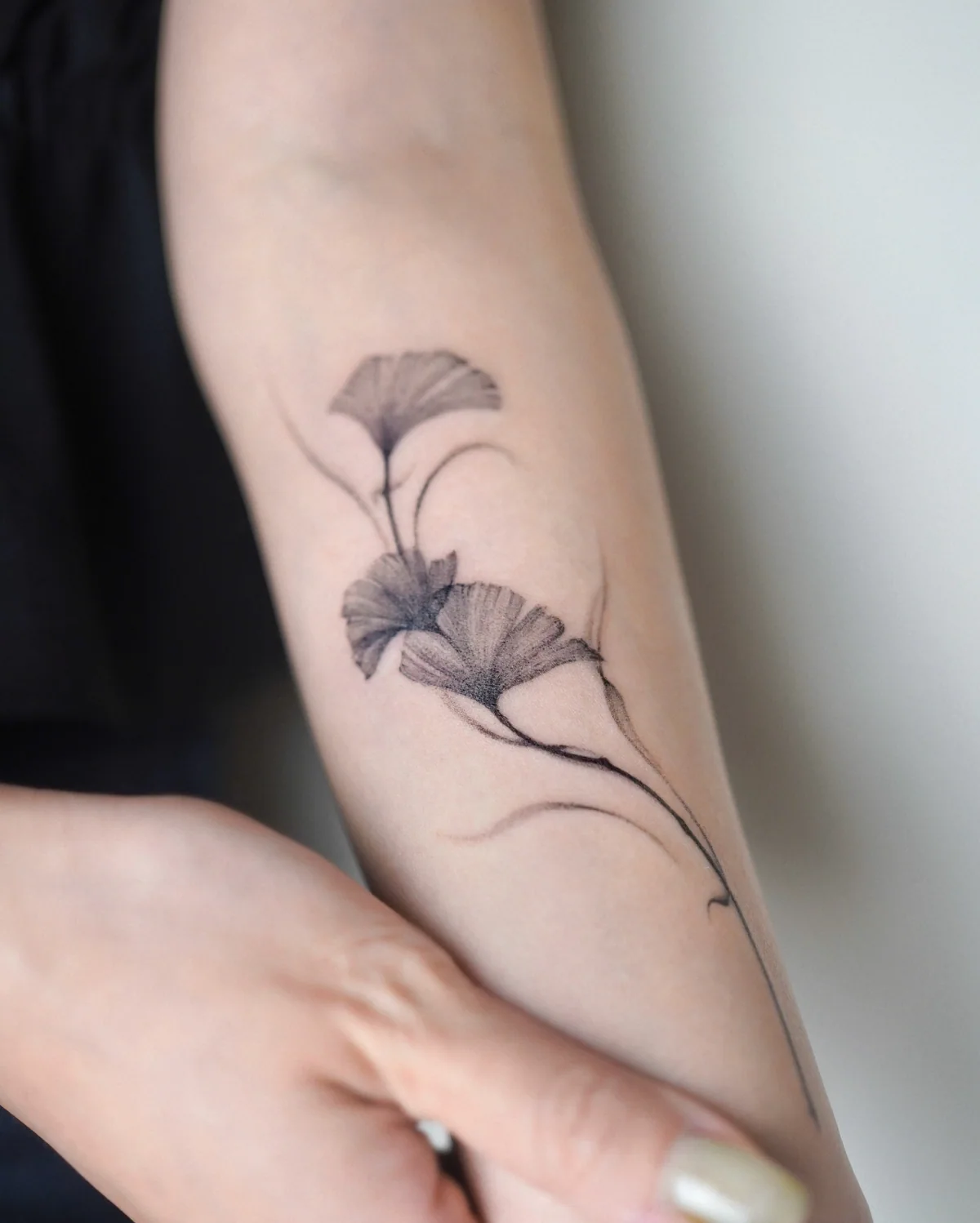 Fine-line ginkgo tattoo by Moon